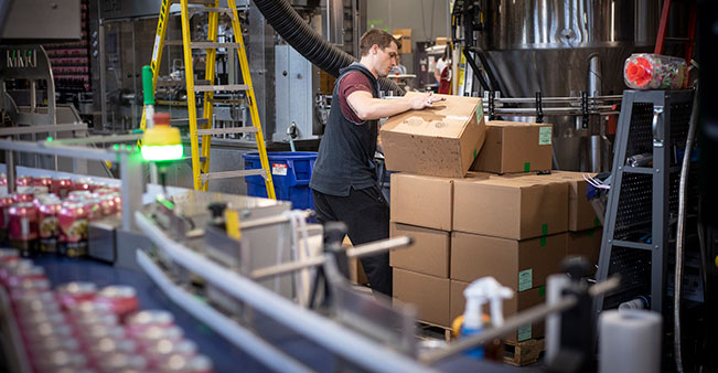 Person moves boxes in warehouse