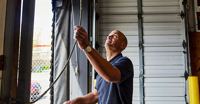 Person closes garage door in warehouse