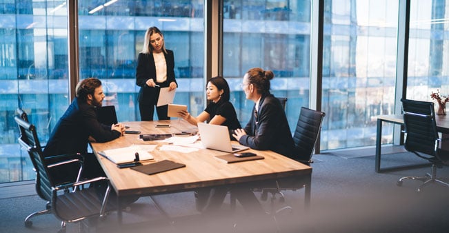 Business people discuss fraud in meeting room