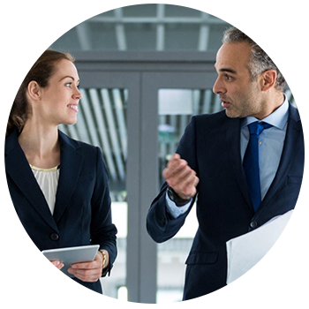 Two businesspeople talk while walking